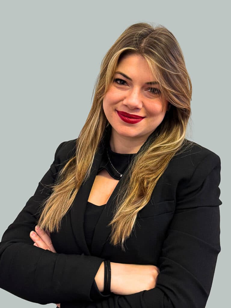 Luca Lovati con capelli lunghi e blazer nero, ritratta con le braccia conserte